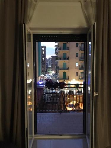 a door to a balcony with a view of a building at COSTA APARTMENT NAPLES in Naples