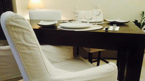 a dining room table with a white chair at a table at La Civetta in Foggia