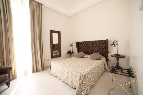 a bedroom with a bed and a mirror at La Civetta in Foggia