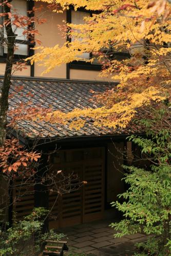 an entrance to a building with a brown door at Ryokan Wakaba in Minamioguni