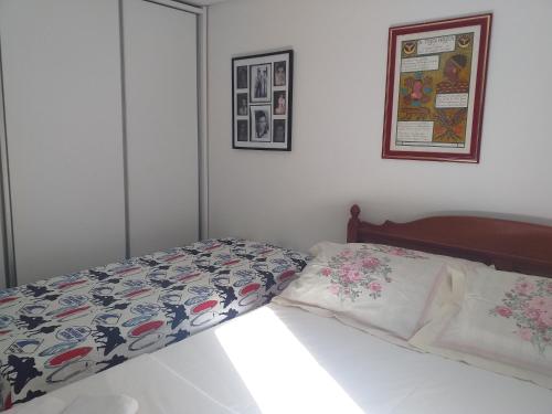 a bedroom with a bed with a comforter and pillows at AMPLA e CONFORTÁVEL SUITE - PERTO DO CENTRO DE CONVENÇÕES-FEIRAS-CONVENÇÕES-RECIFE in Recife