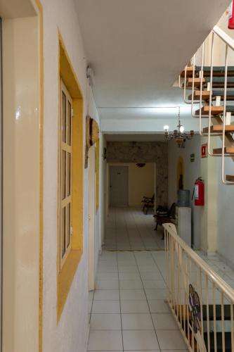 an empty hallway of a building with a staircase at Pequeno Gran Hotel in Aguascalientes