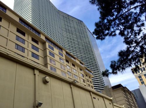 a building with a tall building in the background at GetAways at the Jockey Club in Las Vegas