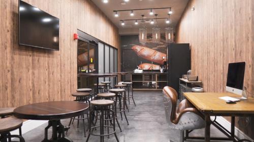 a restaurant with tables and chairs and a bar at Magic Village Views Trademark Collection by Wyndham in Orlando