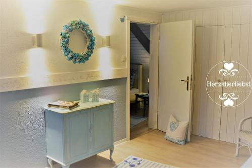 a room with a blue cabinet and a wreath on the wall at Ferienwohnung HERZALLERLIEBST in Bad Lauterberg