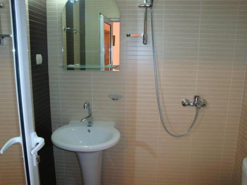 a bathroom with a sink and a shower at Tzvetelina Palace Hotel in Dolna Banya