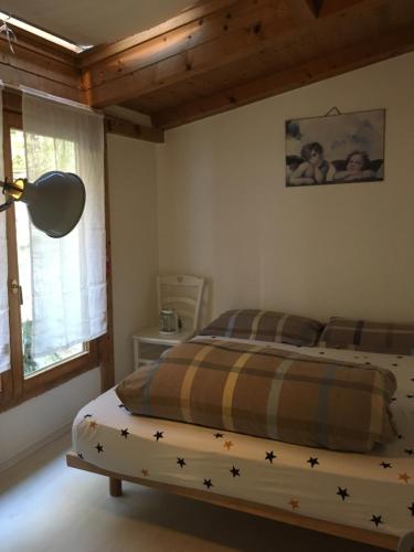 a bedroom with a bed with stars on it at Appartamento Ellen in Nago-Torbole