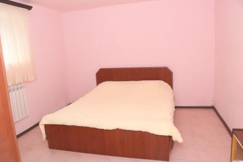 a small bedroom with a bed with a white mattress at Уютные апартаменты в малом центре Еревана in Yerevan