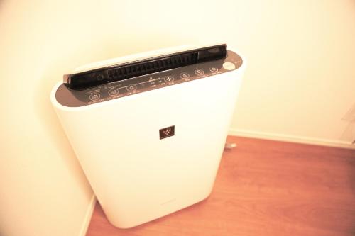 a refrigerator with a cell phone on top of it at Yoshitsuki kaku - Yoshitsuki Apart Hotel in Tokyo