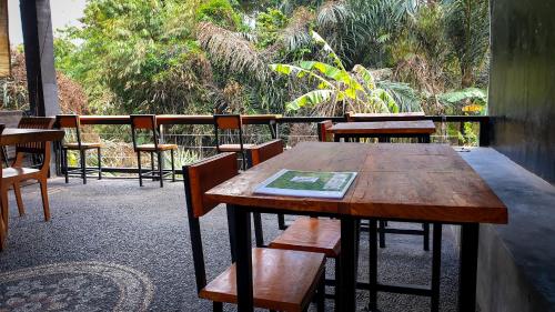 a wooden table and chairs on a balcony at The Paica in Denpasar