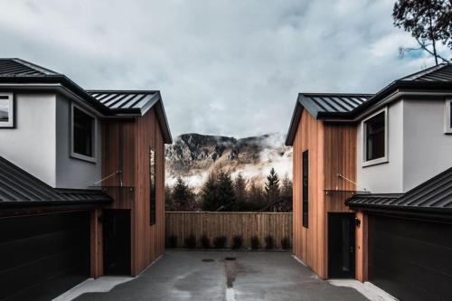 a group of houses with a mountain in the background at Coronet Haven in Queenstown