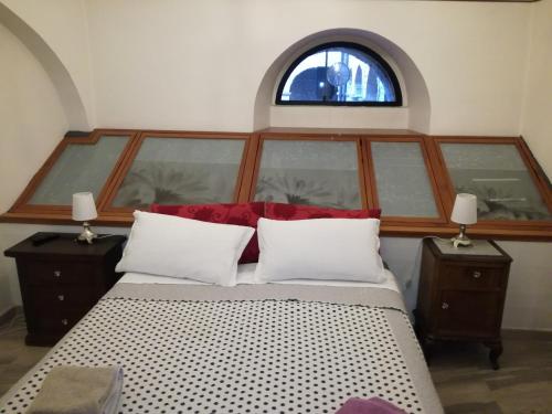 a bedroom with a large bed with a window at Sweet Sweet Home in Tolve