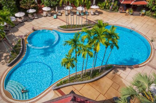 an overhead view of a swimming pool with palm trees at Borei Angkor Resort & Spa in Siem Reap