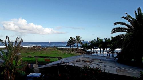 a view of a beach with palm trees and the ocean at Hostal Vieroto in Hanga Roa