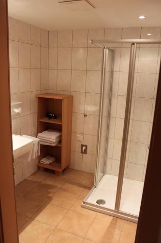 a bathroom with a shower and a sink at Hotel Garni Dorfblick in Sankt Anton am Arlberg