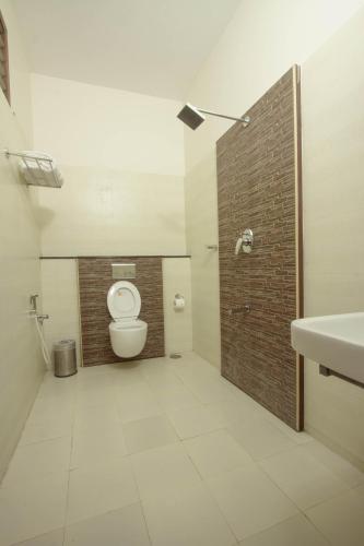 a bathroom with a toilet and a sink at G S Resort in Velankanni