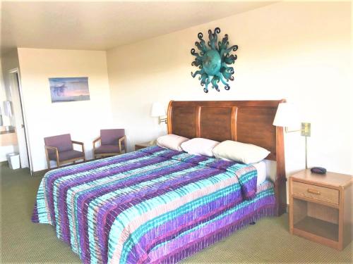 a hotel room with a bed and two chairs at COPPER STAY INN Benson AZ I-10 Exit 304 in Benson