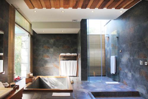 a bathroom with a shower and a sink and a tub at ChooArt B&B in Sanyi