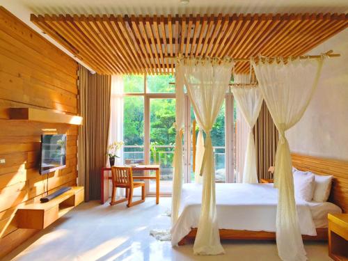 三義鄉的住宿－樹也民宿 ，一间卧室配有一张带窗帘和桌子的床