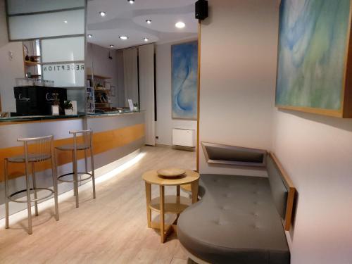 a bar with stools and a counter in a room at Hotel Astor in Pisa