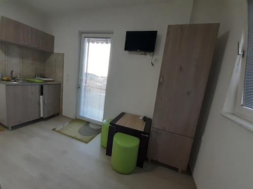a room with a kitchen with a table and a window at NULI apartments in Kruševo