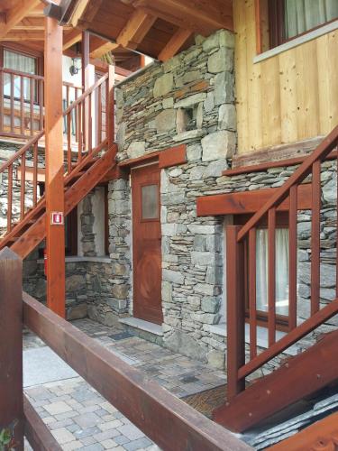 a building with wooden stairs and a wooden door at Eco Chalet Maison Dominique in Challand Saint Anselme
