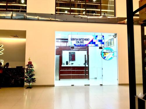 a christmas tree in front of a door with a sign on it at Mercu Summer Suites Bernice KLCC in Kuala Lumpur
