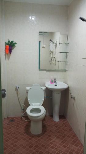 a bathroom with a toilet and a sink at Kata S. T. House in Kata Beach