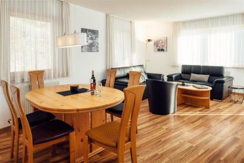 a living room with a table and a couch at Apart Ideal Serfaus in Serfaus