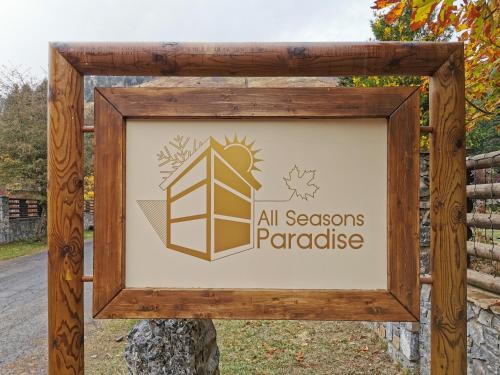 a sign for the all seasons parakeets paradise at All Seasons Paradise in Khrisovítsion
