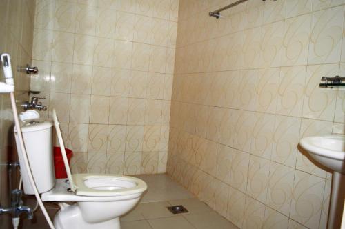 a bathroom with a toilet and a sink at Hotel Water Orchid in Cox's Bazar