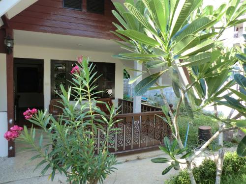 um alpendre de uma casa com árvores e plantas em The Krabi Forest Homestay em Praia de Ao Nang