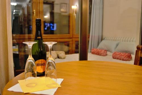 two wine glasses sitting on top of a wooden table at "Ecológico con Piscina Climatizada" y Sauna!! in Riaza