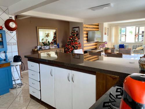 a kitchen with a christmas tree in a room at Recanto da Sol in Florianópolis