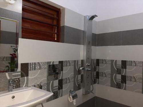 a bathroom with a sink and a mirror at SUN VIEW Beach Resort in Varkala