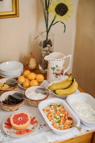 a table topped with plates of food and fruit at High Timbers Lodge in Tokai