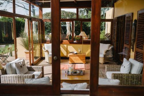 a living room with chairs and a table at High Timbers Lodge in Tokai