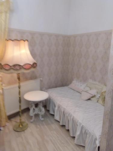 a small bedroom with a bed and a lamp at Marea20 in Międzyzdroje
