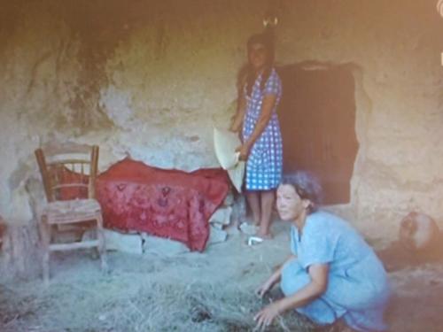 an old photo of a woman standing in a room at Fantastic Matala 2 in Matala