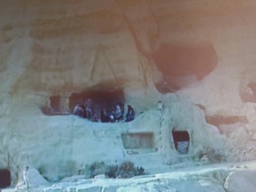a group of people standing in a cave at Fantastic Matala 2 in Matala