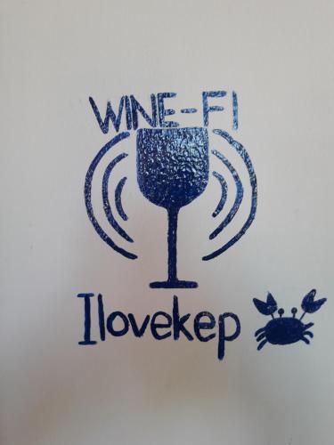 a sign for a wine lover with a glass of wine at Raingsey Bungalow in Kep