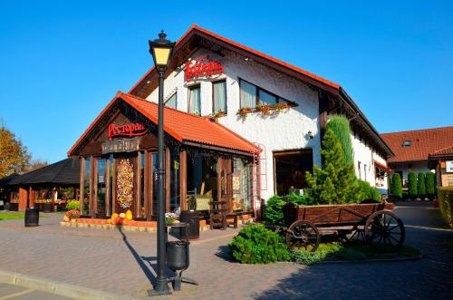 a building with a bench in front of it at Hotel Complex Legenda in Ivano-Frankivsʼk