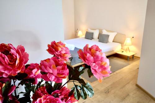 a room with a bed and flowers in the foreground at Hotel Amfora in St. St. Constantine and Helena