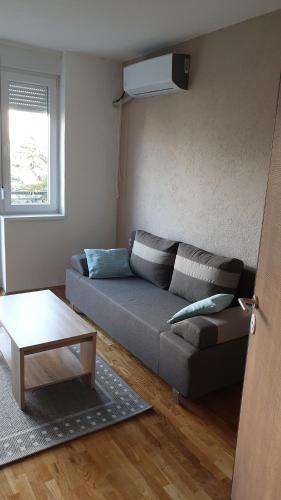 a living room with a couch and a table at Apartments in city center in Kumanovo