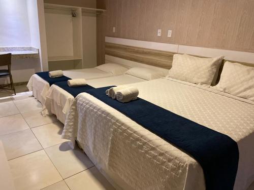 two twin beds in a room with at FPH Hotel in Aracaju