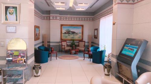 a waiting room with chairs and a video game at Spark Residence Hotel in Sharjah