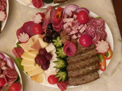 a plate of food with different types of food at Pensiunea La Cazemata Bucov in Satu Bucovei