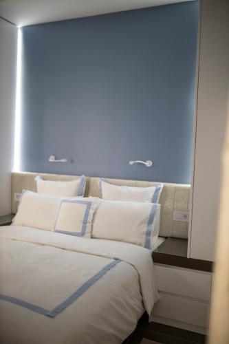 a bedroom with a large bed and a mirror at Pupin Palace Apartments in Novi Sad