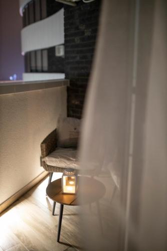 a room with a bench with a candle on a table at Pupin Palace Apartments in Novi Sad