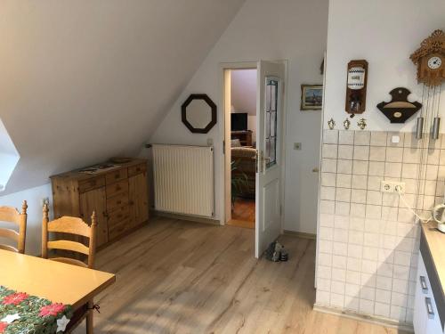 an attic room with a table and a staircase at Liebetrau Apartment in Gotha